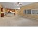 Open-concept living area with a kitchen island, carpeted floors, and abundant natural light at 11321 Ledgement Ln, Windermere, FL 34786