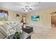 Bright living room with plush seating, elegant decor, and a ceiling fan for added comfort at 11321 Ledgement Ln, Windermere, FL 34786