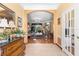 Elegant home foyer with archway flowing into a formal living room and decorative furnishings at 11321 Ledgement Ln, Windermere, FL 34786