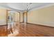 Formal living room boasts hardwood floors, elegant chandelier, and inviting entryway at 11321 Ledgement Ln, Windermere, FL 34786