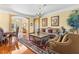 Elegant living room featuring hardwood floors, a decorative chandelier, and sophisticated furnishings at 11321 Ledgement Ln, Windermere, FL 34786