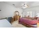 Comfortable main bedroom with ceiling fan, desk, and adjoining sitting area at 11321 Ledgement Ln, Windermere, FL 34786