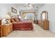 Spacious main bedroom with large window, ceiling fan, and coordinating furniture at 11321 Ledgement Ln, Windermere, FL 34786