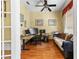 Office features hardwood floors, large windows, a comfortable couch and a ceiling fan for climate control at 11321 Ledgement Ln, Windermere, FL 34786