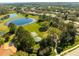 An aerial shot showcases the park with the sports court, pavilion, and the pond beyond at 11321 Ledgement Ln, Windermere, FL 34786