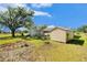 Another view of the expansive backyard with a shed and storage structure on the property at 14285 Oconner Rd, Kathleen, FL 33849