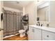 Clean bathroom with black hardware, wood-look floor, and patterned shower curtain at 14285 Oconner Rd, Kathleen, FL 33849