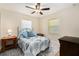 Comfortable bedroom with a ceiling fan, soft blue accents, and natural light at 14285 Oconner Rd, Kathleen, FL 33849