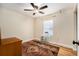 Functional bedroom features wood-look floors, neutral walls, and a ceiling fan at 14285 Oconner Rd, Kathleen, FL 33849