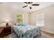 Cozy bedroom with ceiling fan, blue accents, and natural lighting at 14285 Oconner Rd, Kathleen, FL 33849