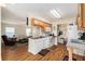 View of the kitchen with an open layout to the living room, wood cabinets, and appliances at 14285 Oconner Rd, Kathleen, FL 33849