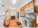 Charming kitchen features wood floors, white appliances, and a cozy dining area at 14285 Oconner Rd, Kathleen, FL 33849