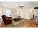 Bright living room features a ceiling fan, natural light, and wood laminate flooring at 14285 Oconner Rd, Kathleen, FL 33849