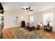 Cozy living room features neutral walls, ceiling fan, and wood laminate flooring at 14285 Oconner Rd, Kathleen, FL 33849