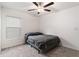 Bedroom with a ceiling fan, gray carpet, and window providing natural light at 1700 Red Loop, Lakeland, FL 33801