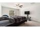 Spacious bedroom featuring a ceiling fan, carpeted floor, and a TV stand with a flat screen TV at 1700 Red Loop, Lakeland, FL 33801