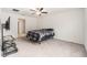 Bedroom featuring a ceiling fan, carpeted floor, and a TV stand with a flat screen TV at 1700 Red Loop, Lakeland, FL 33801