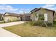 View of a single-story home with a well-kept lawn and attached two-car garage at 1700 Red Loop, Lakeland, FL 33801
