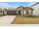 Charming single-story home featuring a two-car garage and well-maintained front yard at 1700 Red Loop, Lakeland, FL 33801
