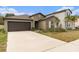 Attractive single-story home with a well-manicured lawn and concrete driveway at 1700 Red Loop, Lakeland, FL 33801