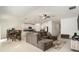 Open-concept living area with tile floors, a large sectional sofa, and a modern kitchen at 1700 Red Loop, Lakeland, FL 33801