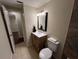 Bathroom featuring a single vanity with tile floors and warm neutral paint at 231 4Th St, Winter Haven, FL 33880