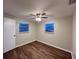 This bedroom features wood-look floors, neutral walls, ceiling fan, and two windows at 231 4Th St, Winter Haven, FL 33880
