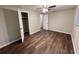 This bedroom features wood-look floors, neutral walls, ceiling fan, and an open closet at 231 4Th St, Winter Haven, FL 33880