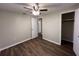 This bedroom features wood-look floors, neutral walls, ceiling fan, and closet at 231 4Th St, Winter Haven, FL 33880
