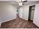This bedroom features wood-look floors, neutral walls, ceiling fan, and a closet at 231 4Th St, Winter Haven, FL 33880