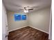 This bedroom features wood-look floors, neutral walls, and a ceiling fan at 231 4Th St, Winter Haven, FL 33880
