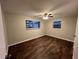 Bedroom with hardwood floors, ceiling fan, and two windows at 231 4Th St, Winter Haven, FL 33880