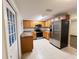 Traditional kitchen with stainless steel appliances, wood cabinets and tile floors at 231 4Th St, Winter Haven, FL 33880