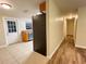 Open kitchen with stainless steel refrigerator and matching appliances, door and tile flooring at 231 4Th St, Winter Haven, FL 33880
