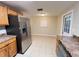 Open kitchen with stainless steel refrigerator and matching appliances and tile flooring at 231 4Th St, Winter Haven, FL 33880