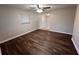 Living area with ceiling fan, showcasing the updated flooring and neutral paint scheme at 231 4Th St, Winter Haven, FL 33880