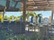 Outdoor bar area with thatched roof, multiple TVs, and outdoor seating at 3151 Sunset Walk Dr # 314, Kissimmee, FL 34747