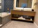 Luxurious bathroom with a soaking tub, stylish vanity, and elegant blue patterned walls at 3151 Sunset Walk Dr # 314, Kissimmee, FL 34747