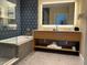 Modern bathroom with a soaking tub, dual sink vanity, and elegant finishes at 3151 Sunset Walk Dr # 314, Kissimmee, FL 34747