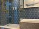 Modern bathroom featuring glass shower, soaking tub, luxury amenities, and stylish blue patterned walls with gold fixtures at 3151 Sunset Walk Dr # 314, Kissimmee, FL 34747