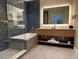 Well-appointed bathroom featuring a tub, a walk-in shower, and dual-sink vanity at 3151 Sunset Walk Dr # 314, Kissimmee, FL 34747