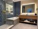 Modern bathroom with a soaking tub, glass shower, and dual-sink vanity at 3151 Sunset Walk Dr # 314, Kissimmee, FL 34747