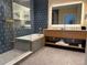 Contemporary bathroom featuring a tub, a walk-in shower, and a well lit vanity at 3151 Sunset Walk Dr # 314, Kissimmee, FL 34747