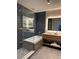 Contemporary bathroom with a glass-enclosed shower, soaking tub, and dual sink vanity at 3151 Sunset Walk Dr # 314, Kissimmee, FL 34747