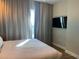 Cozy bedroom featuring a king-size bed, ambient lighting, and blackout curtains at 3151 Sunset Walk Dr # 314, Kissimmee, FL 34747