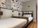 Stylized bedroom featuring two twin beds, modern decor, and a lively accent wall at 3151 Sunset Walk Dr # 314, Kissimmee, FL 34747