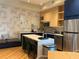 Stylish kitchen with an island, modern appliances, and an adjacent dining area at 3151 Sunset Walk Dr # 314, Kissimmee, FL 34747