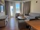 Inviting living room with a sofa, chair, TV, and sliding glass doors to the outside at 3151 Sunset Walk Dr # 314, Kissimmee, FL 34747