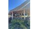 Tropical outdoor bar with multiple TVs, a thatched roof, and lush landscaping for relaxed entertainment at 3151 Sunset Walk Dr # 314, Kissimmee, FL 34747