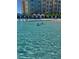 Crystal clear pool water reflecting the sky and the colorful building, perfect for swimming at 3151 Sunset Walk Dr # 314, Kissimmee, FL 34747